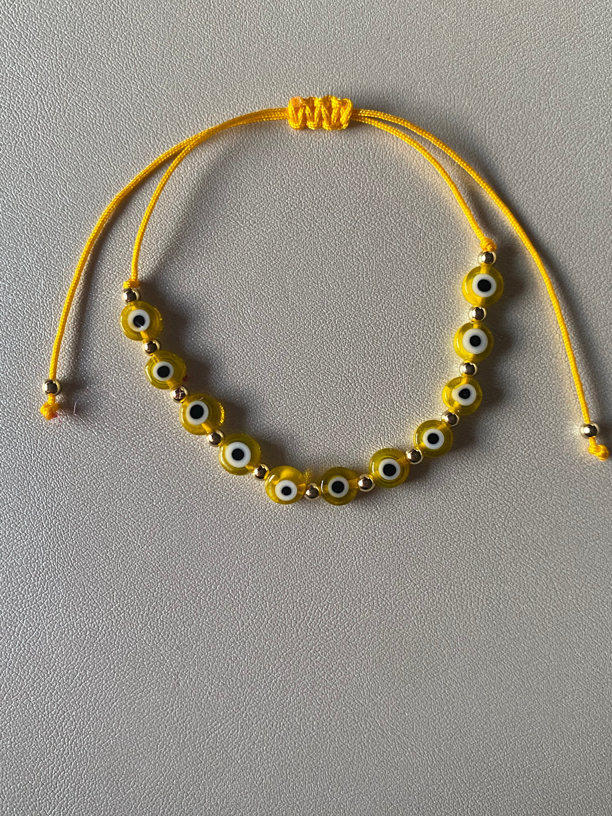 Yellow ojito bracelet gold plated beads