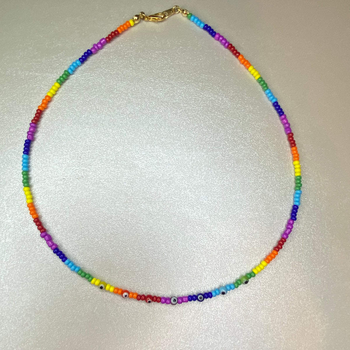 Rainbow necklace with small ojitos