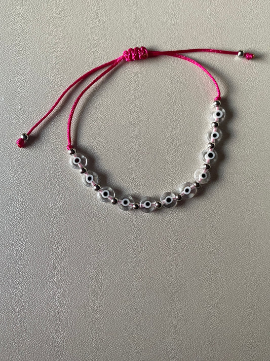 Clear ojitos bracelet with pink string